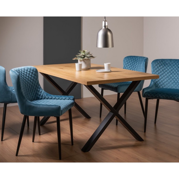 Bentley Designs Ramsay Rustic Oak Effect Melamine 6 Seater X Leg Dining Table With 4 Cezanne Petrol blue Velvet Fabric Chairs
